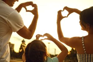 Family showing hearts with their hands